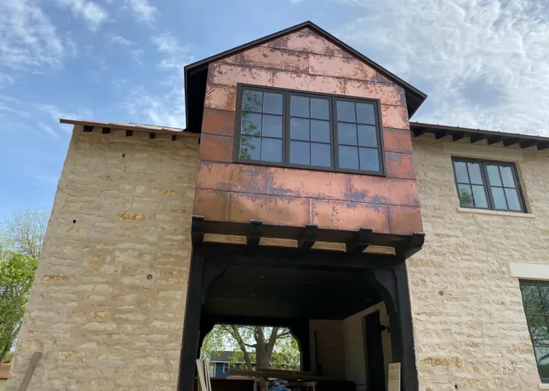 Copper metal panel facade on a stone building for Skylight Installation in New Braunfels